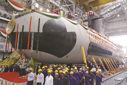 An April 6, 2015 file photo of employees standing in front of Indian Navyu2019s first Scorpene submarine before being undocked from Mazagon Docks in Mumbai.