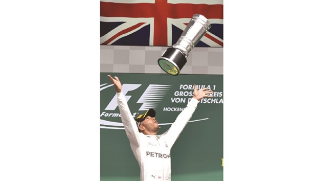 In this July 31, 2016, picture, Mercedes driver Lewis Hamilton celebrates after winning the German Grand Prix at the Hockenheim circuit. (AFP)