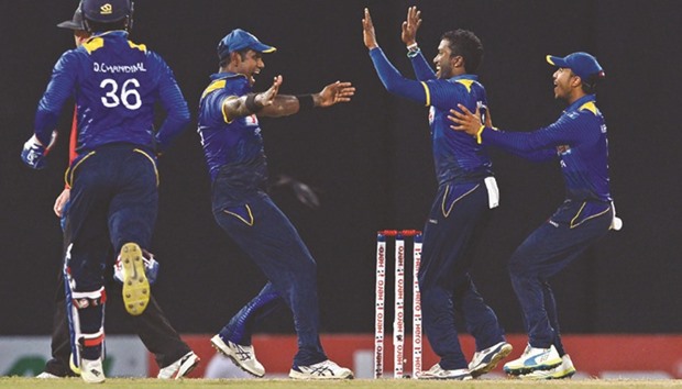 Sri Lankau2019s Amila Aponso (C) celebrates with teammates after he dismissed Australiau2019s captain Steven Smith at the R Premadasa International Cricket Stadium in Colombo yesterday.