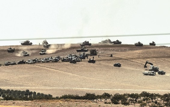This picture taken from the Turkish Syrian border city of Karkamis in the southern region of Gaziantep, yester shows Turkish army tanks and pro-Ankara Syrian opposition fighters moving 2km west from the Syrian Turkish border town of Jarabulus. Turkeyu2019s army backed by international coalition air strikes launched an operation involving fighter jets and elite ground troops to drive Islamic State militants out of a key Syrian border town.