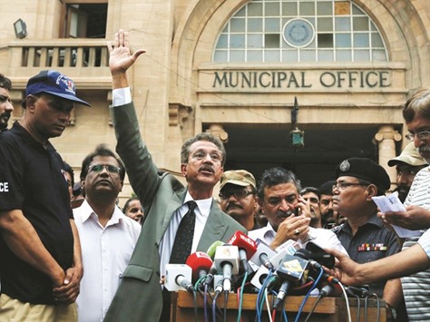 Waseem Akhtar, mayor nominee of Muttahida Qaumi Movement (MQM) political party, gestures while speaking to members of the media (unseen) after the ballot for mayor outside the Municipal Corporation Building in Karachi yesterday.