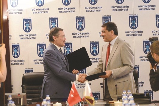 HE the Minister of Municipality and Environment Mohamed bin Abdullah al-Rumaihi and Ankara Metropolitan Municipality Mayor, Melih Gokcek, exchanging documents after signing the twinning agreement in Ankara yesterday.