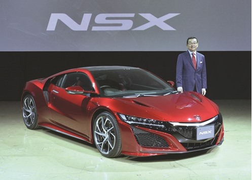 Honda CEO Takahiro Hachigo poses in front of a new Honda NSX at its Japan launch event in Tokyo. Generating profit from the NSX may be a struggle, but by focussing on both functional cars and also advanced performance we will raise the Honda brand, Hachigo said.