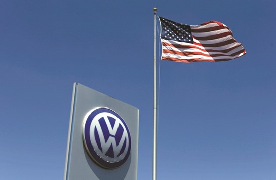 A US flag flutters above a Volkswagen dealership in Carlsbad, California. In a statement yesterday, lawyers for dealerships in the US said VW had agreed to buy back unfixable used vehicles under the same terms as a buy-back plan for consumers and independent dealers.
