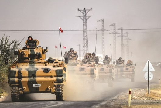 Turkish Army tanks drive to the Syrian-Turkish border town of Jarabulus yesterday.