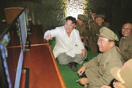Kim Jong-Un is seen with his military aides during the missile test in this undated photo released by North Koreau2019s Korean Central News Agency (KCNA).