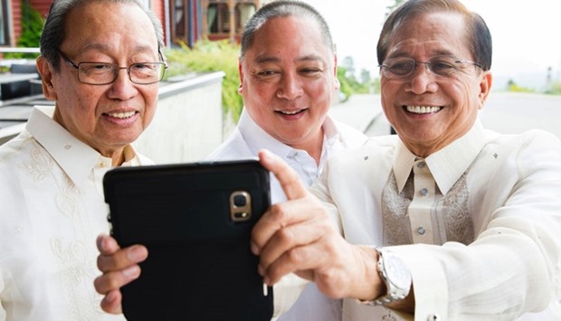 Exiled Chief of the National Democratic Front of Philippines (NDFP) Jose Maria Sison (L), government member Joey Fornier and Phillipines Presidential Peace Adviser Jesus Dureza make a selfie prior a meeting on peace negotiations between the Philippean government and the National Democratic Front of the Philippines in Oslo, Norway, on August 22, 2016.