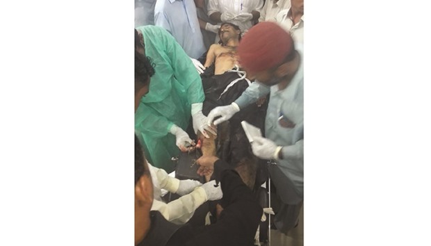 Pakistani paramedics give treatment to an injured policeman at a hospital following an attack in Gwadar late Thursday.