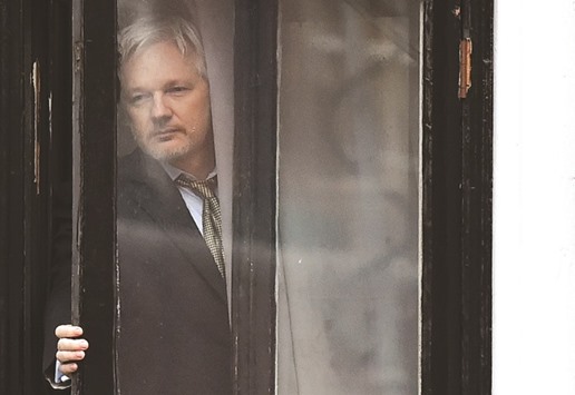 This file photo taken on February 5 shows Assange as he comes out on the balcony of the Ecuadorian embassy in London to address the media.