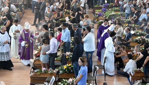 People attend a funeral service for victims of the earthquake in Ascoli Piceno