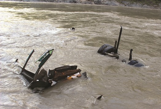 This view shows the wreckage of a passenger bus lying in the Trishuli river at Mugling, some 90kms west of Kathmandu.