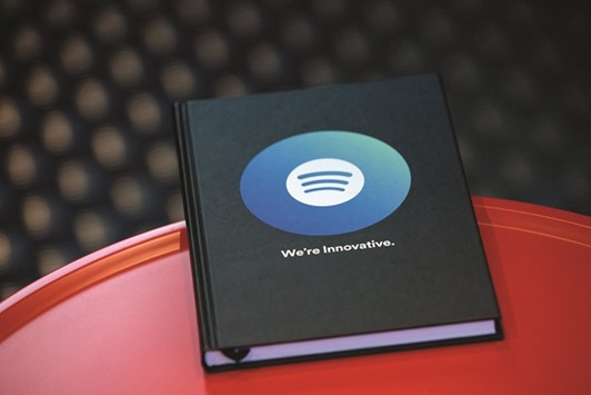 Spotify logo is displayed on the cover of a notebook inside the music streaming companyu2019s offices in Berlin. Spotify has been retaliating against musicians who introduce new material exclusively on rival Apple Music by making their songs harder to find.