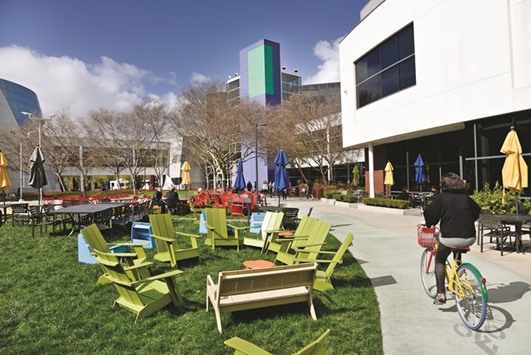 A cyclist rides past Google offices inside the Googleplex headquarters in Mountain View, California. Google parent Alphabet and food processor Archer Daniels Midland are among the companies that have sold more than $5bn of corporate bonds in the past two months to pay off at least part of their short-term debt known as commercial paper.