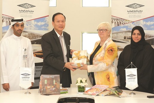 Chaiyindeepum donating the books to Dr Claudia Lux, Project Director of Qatar National Library.