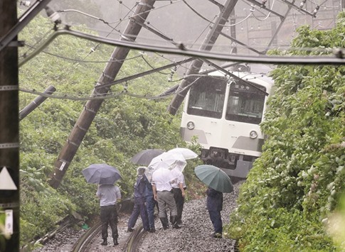 DERAILED:  This picture taken on August 22 shows a derailed train in a landslide on the Seibu Tamako line in Higashimurayama, western Tokyo. A powerful typhoon struck near Tokyo on Monday, the first in 11 years to come ashore in the densely populated region, temporarily shutting down a major city airport and grounding more than 500 flights nationwide. Typhoon Mindulle made landfall at about 12:30 pm (0330 GMT) in Tateyama city 80 kilometres (50 miles) southeast of Tokyo, the Japan Meteorological Agency said.