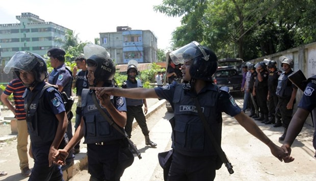 Bangladesh police stand guard at the scene of an operation to storm a militant hideout in Narayanganj, some 25 kms south of Dhaka on August 27, 2016