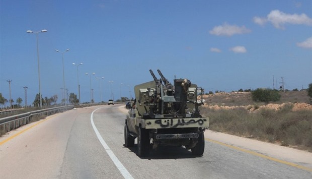 A fighter from Libyan forces allied with the U.N.-backed government drives a military truck in Sirte, Libya, yesterday.