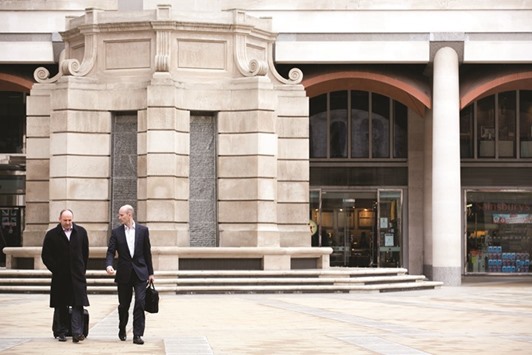 Pedestrians walk across Paternoster Square in front of the London Stock Exchange  headquarters. Pension deficits at the FTSE 100 members have increased to u00a346bn through July 31 from u00a325bn a year earlier.