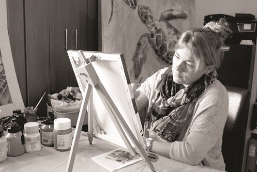 ENGROSSED: Artist Verity Watkins works on a painting. She manages the Watkins Artwork, a joint venture with her husband Stephen, also an artist. Photo by Jacinthe Lamontagne-Lecomte