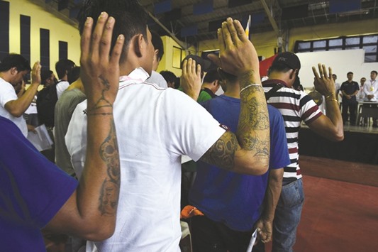 This photo taken on July 18, 2016 shows drug users and dealers taking oath after they voluntarily surrendered to local authorities in Tanauan town, Batangas province, south of Manila.