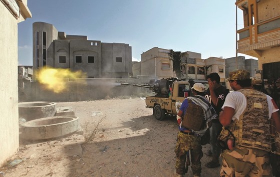 Members of Libyan forces allied with the UN-backed government fire a weapon towards Islamic State militants in neighbourhood Number One in central Sirte,