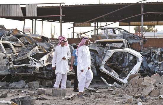 Saudis walk past wreckages at a market for vehicles on Saturday in the Saudi border city of Najran, a week after it was struck by a rocket fired from Yemen.  Cross-border attacks into Saudi Arabia have intensified since the suspension in early August of UN-brokered peace talks between the Shia Houthi rebels and their allies, and Yemenu2019s internationally-recognised government.
