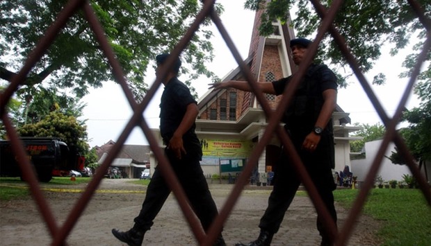 Indonesian policemen examine the Santo Yosef chuch after a man tried to attack a priest in Medan on August 28, 2016