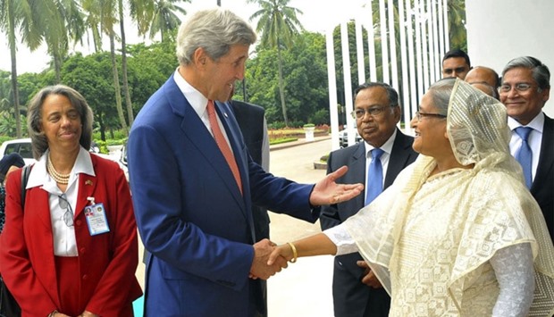 US Secretary of State John Kerry (L) and Bangladesh Prime Minister Sheikh Hasina shake hands ahead of a meeting in Dhaka.