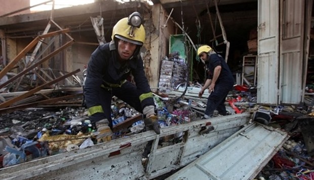 Firemen inspect the site of a June 2016 car bomb attack in the Shia holy city of Kerbala south of Baghdad, Iraq.  June 7, 2016 file picture. REUTERS
