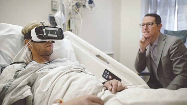 Dr Brennan Spiegel, a gastroenterologist at Cedars-Sinai whou2019s director of health services research at the Los Angeles hospital, observes a patient using a VR headset. Itu2019s still a new and experimental approach, but proponents of virtual reality say that it can be an effective treatment for everything from intense pain to Alzheimeru2019s disease to arachnophobia to depression. And as Facebook, Sony, HTC and others race to build a dominant VR set, the price of hardware has fallen, making the equipment a more affordable option for hospitals looking for alternatives for pain relief.