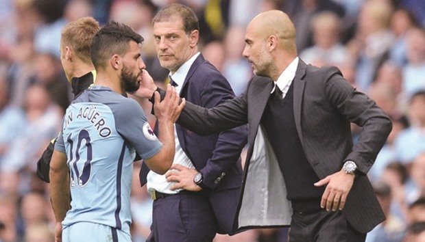 Manchester City manager Pep Guardiola (R) greets striker Sergio Aguero after he was substituted during the EPL match against West Ham United at the Etihad Stadium.