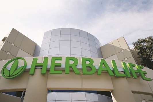 Herbalife signage is displayed outside its office in Carson, California. After the US multi-level marketing company settled a probe of its sales practices with the US Federal Trade Commission last month, top executives assured investors that the company would be able to thrive under the new rules.