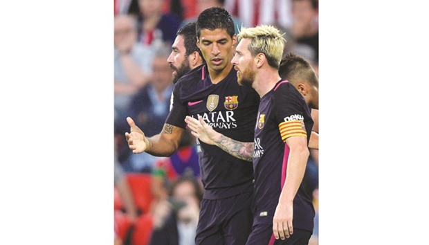 Barcelonau2019s Luis Suarez and Lionel Messi (R) celebrate a goal.