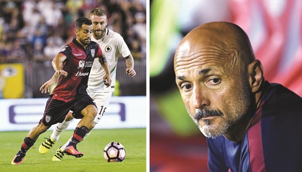 Romau2019s Italian midfielder Daniele De Rossi fights for the ball with Cagliariu2019s Italian defender Marco Sau during their Serie A at the Santu2019Elia stadium in Cagliari.  Roma coach Luciano Spalletti looks on during the match.