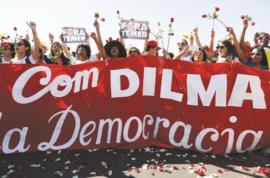 Supporters of suspended President Dilma Rousseff show a banner that reads u2018With Dilma and Democracyu2019 in front of the Brazilian congress in Brasilia yesterday.