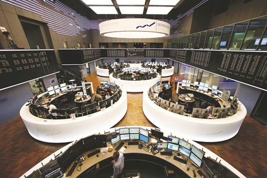 Traders work at the Frankfurt Stock Exchange. The DAX 30 closed down 0.4% to 10,544.44 points yesterday.