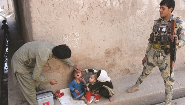 An Afghan health worker administers polio drops to a child during a polio vaccination campaign in the Surkh Rod district of Nangarhar province yesterday.