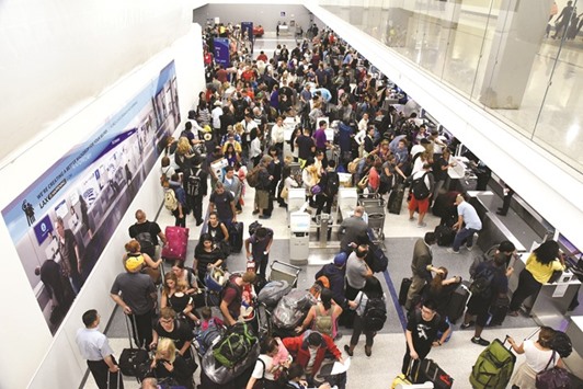 Delayed passengers inside Terminal 7 at Los Angeles International Airport line up to go through TSA security check following a false alarm event in Los Angeles on Sunday.