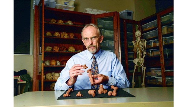 This handout photo released by the Nature hows University of Texas Austin professor John Kappelman with 3D printouts of the skeleton of Lucy, the iconic 3.18mn-year-old hominin found in present-day Ethiopia, illustrating the compressive fractures in her right humerus that she suffered at the time of her death. Lucy died from injuries she sustained having fallen out of a tree, finds a study published in Nature this week.
