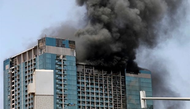 Smoke rises after a fire broke out in a building at Al Maryah Island in Abu Dhabi on Tuesday.