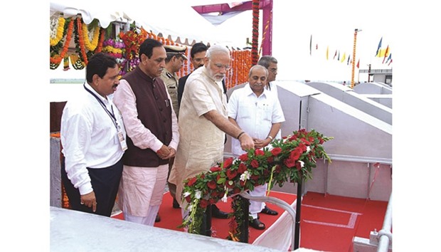 Prime Minister Narendra Modi launching the SAUNI project in Jamnagar yesterday as Gujarat Chief Minister Vijay Rupani and Deputy Chief Minister Nitin Patel look on.