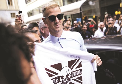 English goalkeeper Joe Hart poses with a supporter shirt upon his arrival for a medical check in Turin yesterday. (AFP)