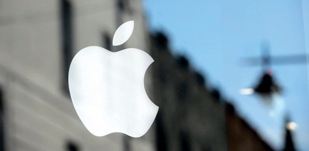 The Apple logo is seen in the window of an authorised reseller store in Galway, Ireland. The worldu2019s richest company benefited from a u201cselective tax treatmentu201d in Ireland that gave it a  u201csignificant advantage over other businesses,u201d the EU regulator said yesterday.