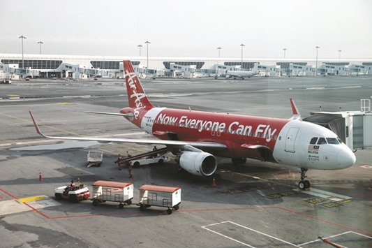 An AirAsia plane on the tarmac at Kuala Lumpur International Airport. Southeast Asiau2019s biggest discount carrier reported a 41% jump in net income for the quarter through June, benefiting from lower fuel costs and a 10% increase in passenger volumes in Malaysia.
