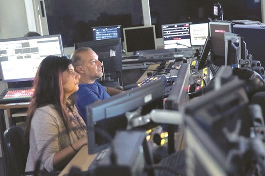 Employees are seen at the control room of Greek private TV channel SKAI in Athens. Greece has eight TV channels broadcasting nationwide, meaning four will have to suspend operations after the licensing process is completed.