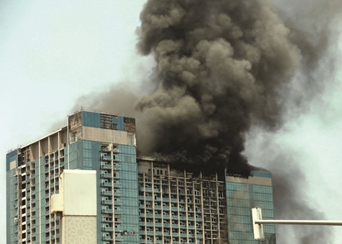 Smoke rises after a fire broke out in a building in Abu Dhabi yesterday.