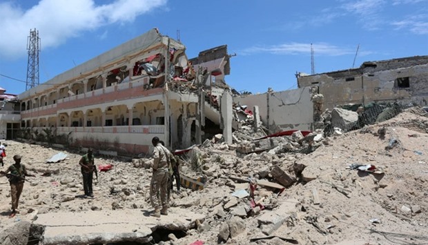 Security forces stand at the SYL hotel that was partly destroyed following a car bomb claimed by al Shabaab Islamist militants outside the president's palace in the Somali capital of Mogadishu, August 30, 2016