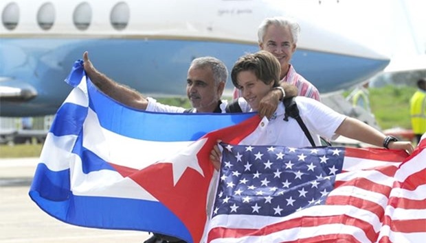 Passengers arriving at the airport of Santa Clara, Cuba on Wednesday on the first commercial flight between the United States and Cuba since 1961, wave Cuban and US flags.
