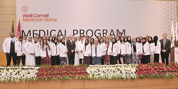The trainee doctors with WCM-Q officials at the white coat ceremony.
