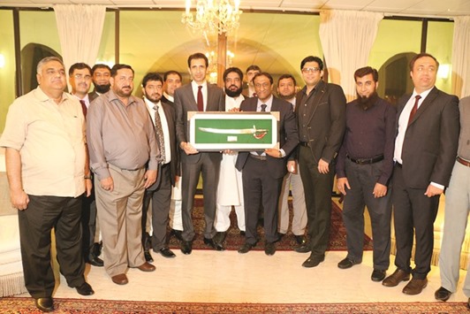 Samee Ullah Naeem, fifth from right, presenting a souvenir to Ambassador of Pakistan Shahzad Ahmad. Photos by Umer Nangiana